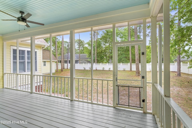 unfurnished sunroom with a ceiling fan