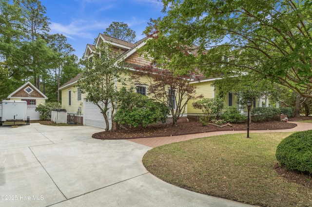 view of property exterior with a garage and concrete driveway