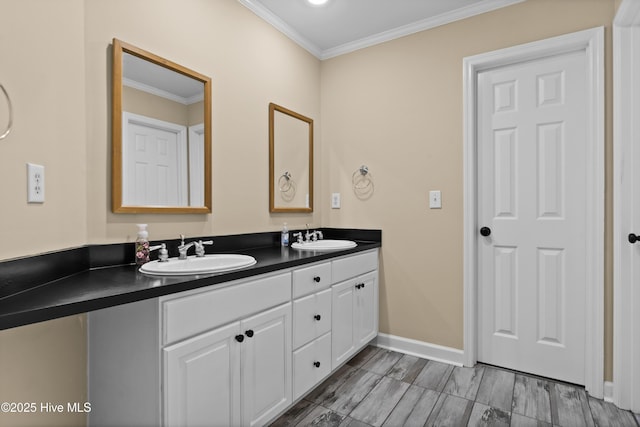 bathroom featuring baseboards, double vanity, crown molding, and a sink