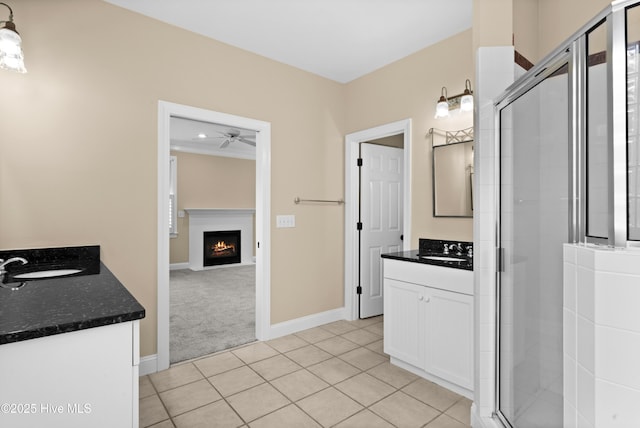 full bathroom with tile patterned floors, two vanities, a shower stall, and a sink