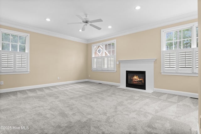 unfurnished living room featuring a wealth of natural light and crown molding
