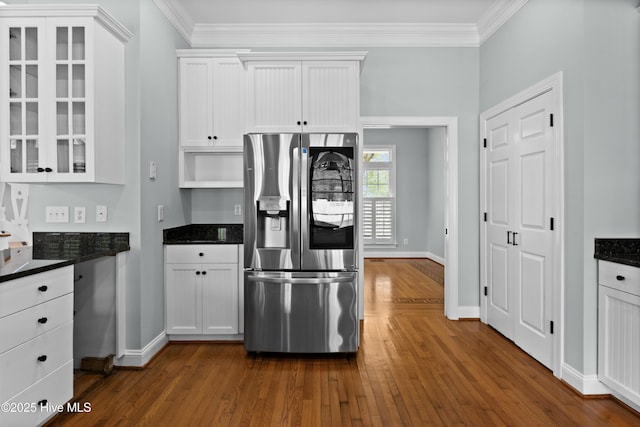 kitchen featuring white cabinetry, stainless steel fridge, crown molding, and dark wood-type flooring