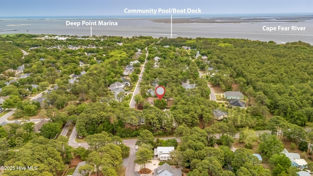 bird's eye view featuring a forest view and a water view