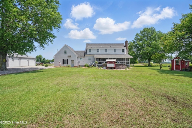 1227 Virginia Rd, Edenton, NC 27932 - back of house featuring an outbuilding, a lawn, a sunroom, and a chimney