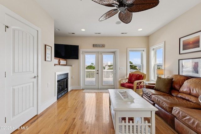 1605 Mackerel Ln Unit 2, Carolina Beach, NC 28428 - living room featuring a ceiling fan, light wood-type flooring, a glass covered fireplace, french doors, and recessed lighting