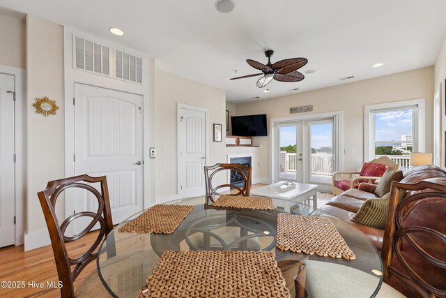 1605 Mackerel Ln Unit 2, Carolina Beach, NC 28428 - living room with light wood-style floors, ceiling fan, french doors, a fireplace, and recessed lighting