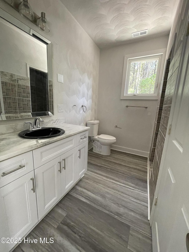 433 Riversound Dr, Edenton, NC 27932 - bathroom featuring wood finished floors, visible vents, toilet, vanity, and baseboards