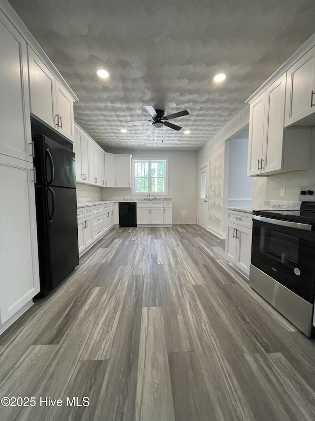 433 Riversound Dr, Edenton, NC 27932 - kitchen with a ceiling fan, wood finished floors, black appliances, light countertops, and recessed lighting