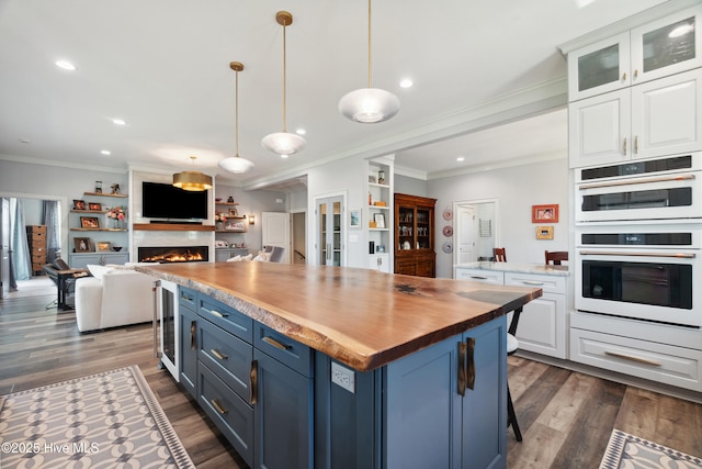 333 N Island Xing, Edenton, NC 27932 - kitchen with double oven, ornamental molding, blue cabinetry, and white cabinetry