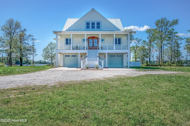 333 N Island Xing, Edenton, NC 27932 - coastal inspired home with stairway, a porch, a front yard, a garage, and gravel driveway
