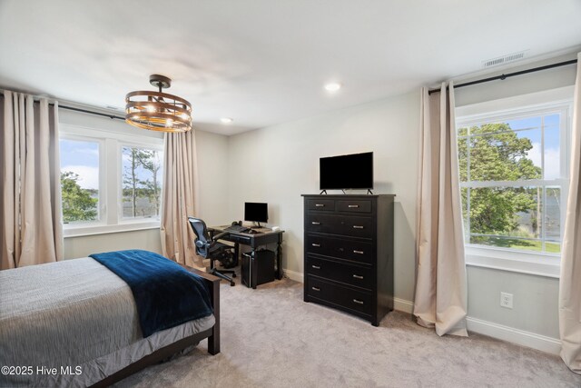 333 N Island Xing, Edenton, NC 27932 - bedroom with visible vents, an inviting chandelier, light colored carpet, and multiple windows
