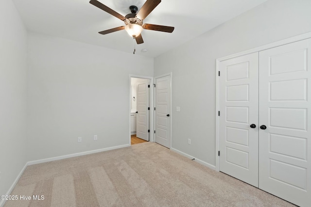 unfurnished bedroom featuring baseboards, ceiling fan, carpet floors, and a closet