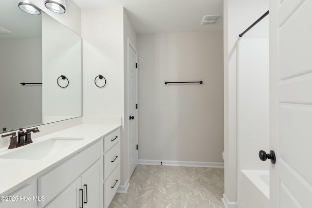 full bath featuring visible vents, vanity, and baseboards