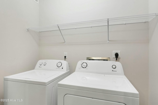 clothes washing area with washer and dryer and laundry area