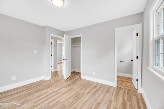 6203 Lynette Cir, Fayetteville, NC 28314 - unfurnished bedroom with light wood-style flooring, baseboards, and multiple windows