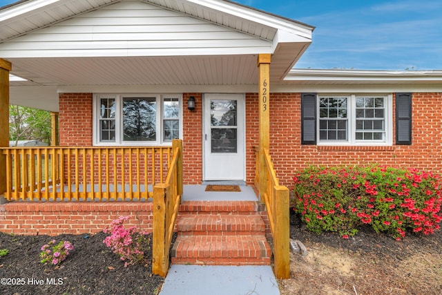 6203 Lynette Cir, Fayetteville, NC 28314 - view of exterior entry featuring brick siding and a porch