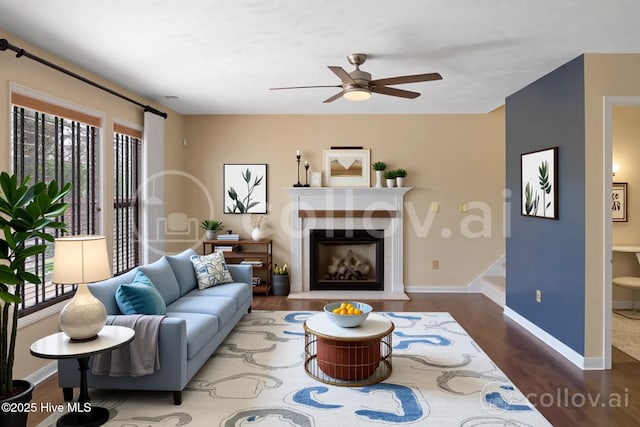 214 Target Ln, Hubert, NC 28539 - living area featuring wood finished floors, baseboards, a ceiling fan, and a premium fireplace