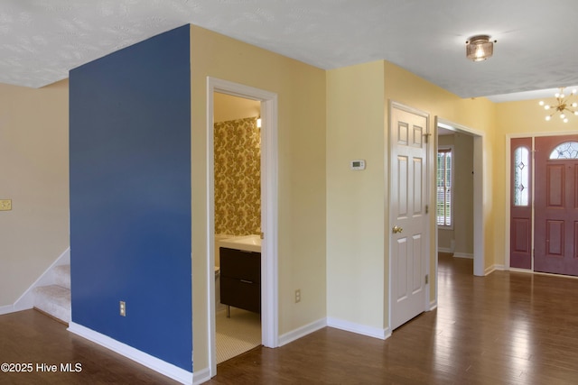 214 Target Ln, Hubert, NC 28539 - foyer entrance featuring wood finished floors, baseboards, stairway, and a chandelier