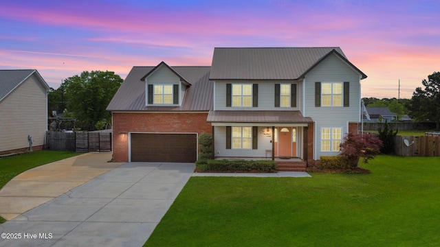 214 Target Ln, Hubert, NC 28539 - traditional-style house featuring concrete driveway, a porch, brick siding, an attached garage, and metal roof