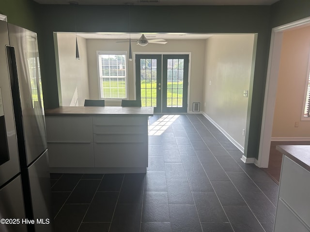 214 Target Ln, Hubert, NC 28539 - unfurnished dining area featuring dark tile patterned flooring, a ceiling fan, and french doors