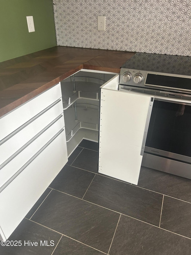 214 Target Ln, Hubert, NC 28539 - kitchen with dark tile patterned floors and stainless steel electric range oven