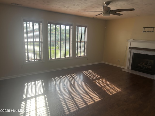 214 Target Ln, Hubert, NC 28539 - unfurnished living room with ceiling fan, baseboards, a fireplace with flush hearth, and wood finished floors