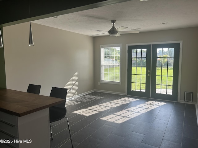 214 Target Ln, Hubert, NC 28539 - unfurnished dining area with healthy amount of natural light, french doors, a ceiling fan, baseboards, and a textured ceiling