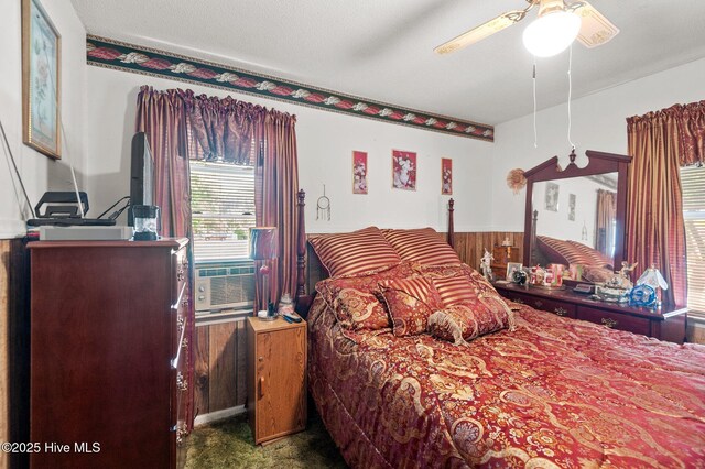 bedroom with cooling unit and ceiling fan
