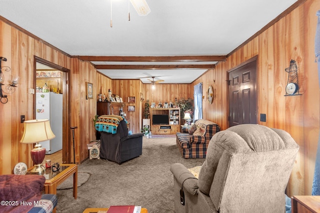 carpeted living room with wooden walls, beam ceiling, and ceiling fan