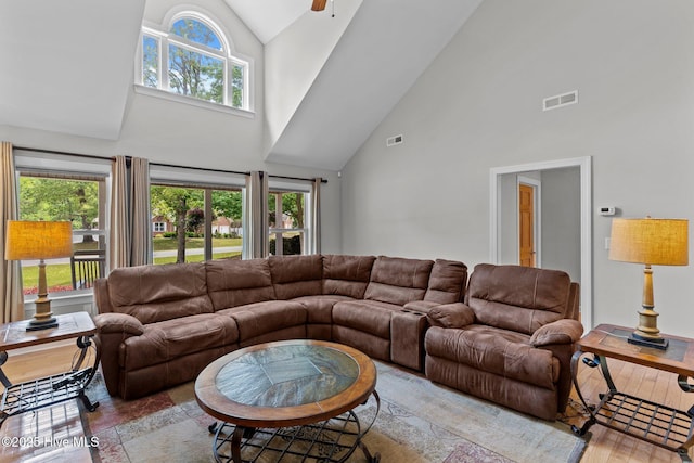 living area featuring visible vents, a ceiling fan, and high vaulted ceiling