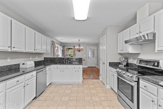kitchen with white cabinets, stainless steel appliances, a sink, a notable chandelier, and under cabinet range hood