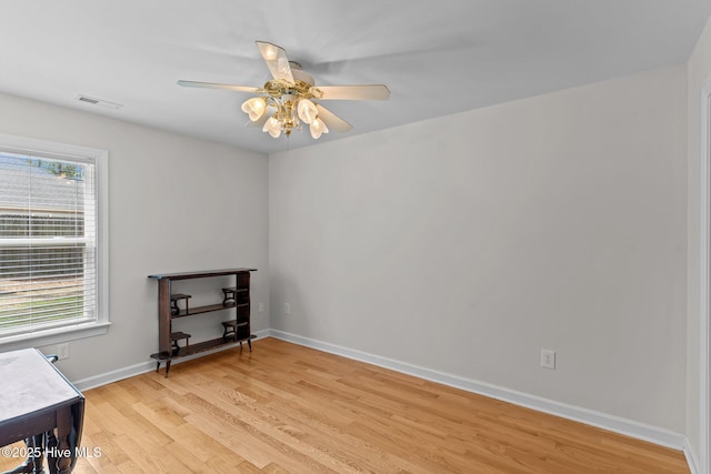interior space featuring visible vents, a healthy amount of sunlight, a ceiling fan, and light wood-style flooring