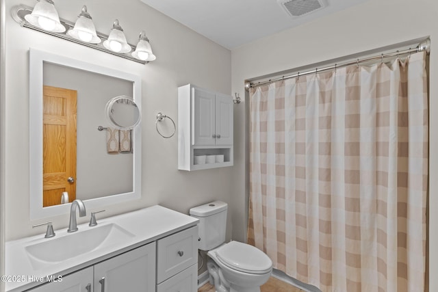 bathroom featuring toilet, visible vents, vanity, and a shower with shower curtain