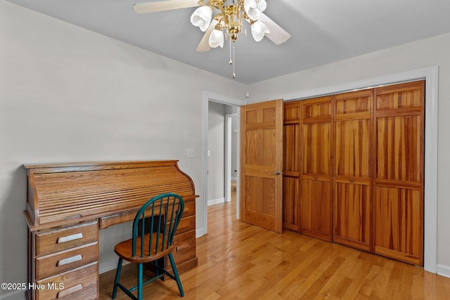 home office with ceiling fan, baseboards, and wood finished floors