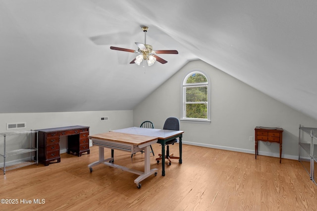 office area with visible vents, light wood-type flooring, ceiling fan, and vaulted ceiling