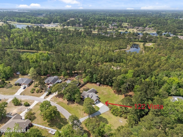 birds eye view of property featuring a view of trees, a water view, and a residential view
