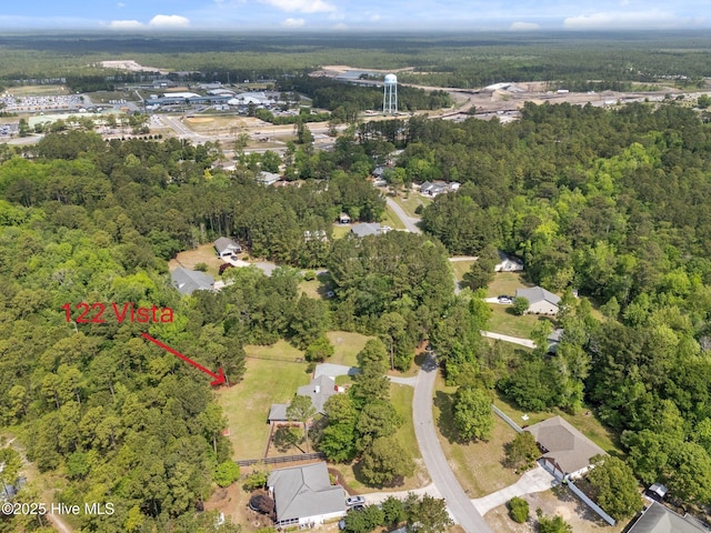 birds eye view of property featuring a wooded view