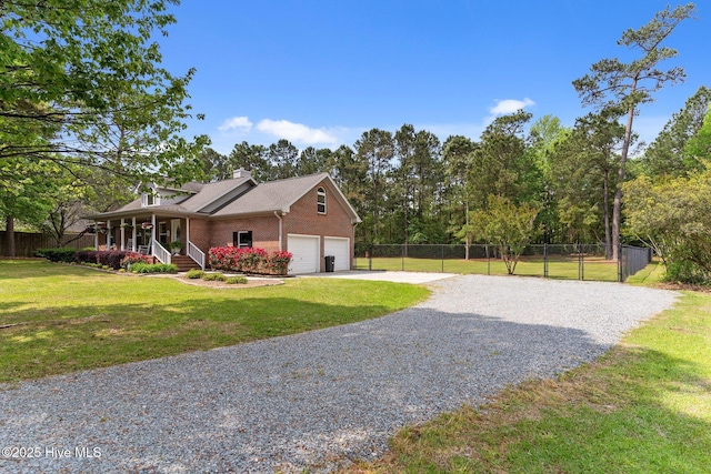 view of property exterior featuring covered porch, fence, a yard, gravel driveway, and brick siding