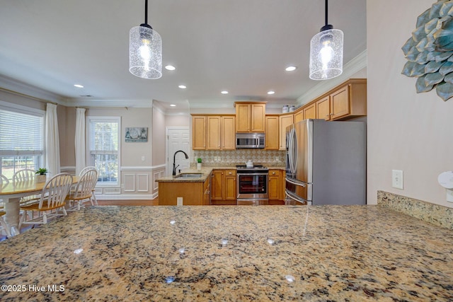 kitchen featuring a decorative wall, a sink, light stone counters, ornamental molding, and stainless steel appliances