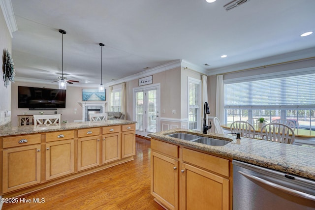 kitchen with stainless steel dishwasher, visible vents, ornamental molding, open floor plan, and a sink