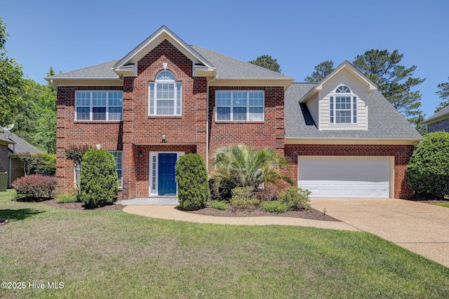 view of front of house featuring roof with shingles, an attached garage, brick siding, a front yard, and concrete driveway