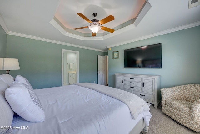 carpeted bedroom with connected bathroom, a raised ceiling, a ceiling fan, visible vents, and ornamental molding