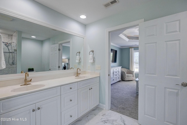 ensuite bathroom with a sink, double vanity, connected bathroom, and visible vents