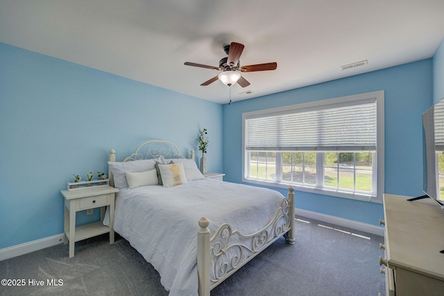 carpeted bedroom with baseboards, multiple windows, a ceiling fan, and visible vents