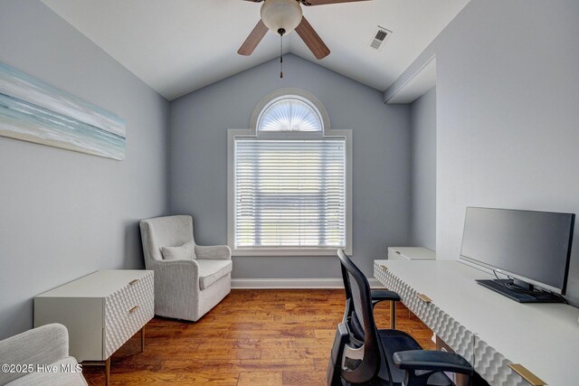 home office with ceiling fan, visible vents, wood finished floors, and vaulted ceiling