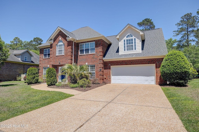 view of front of property featuring brick siding, a shingled roof, a front yard, and concrete driveway