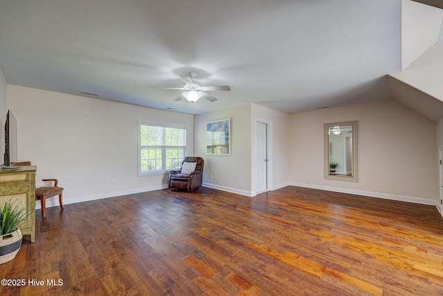 interior space featuring a ceiling fan, baseboards, and wood finished floors