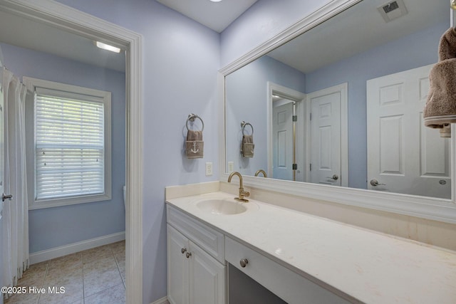 bathroom featuring baseboards, vanity, tile patterned floors, and visible vents