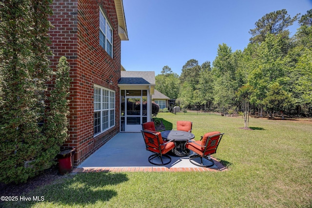 view of yard featuring a sunroom and a patio area