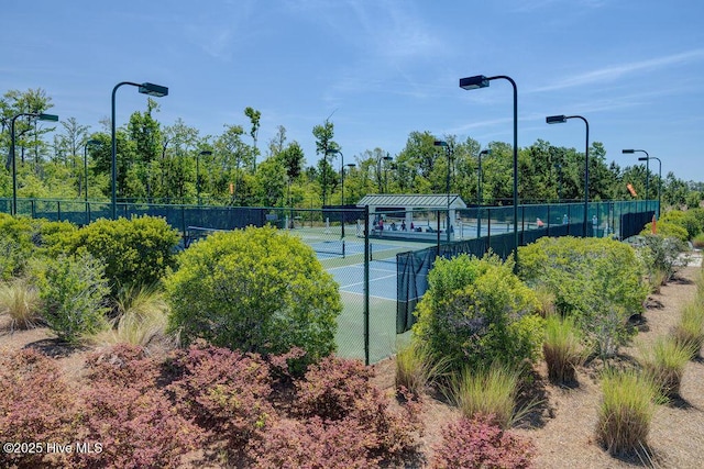 view of sport court featuring fence
